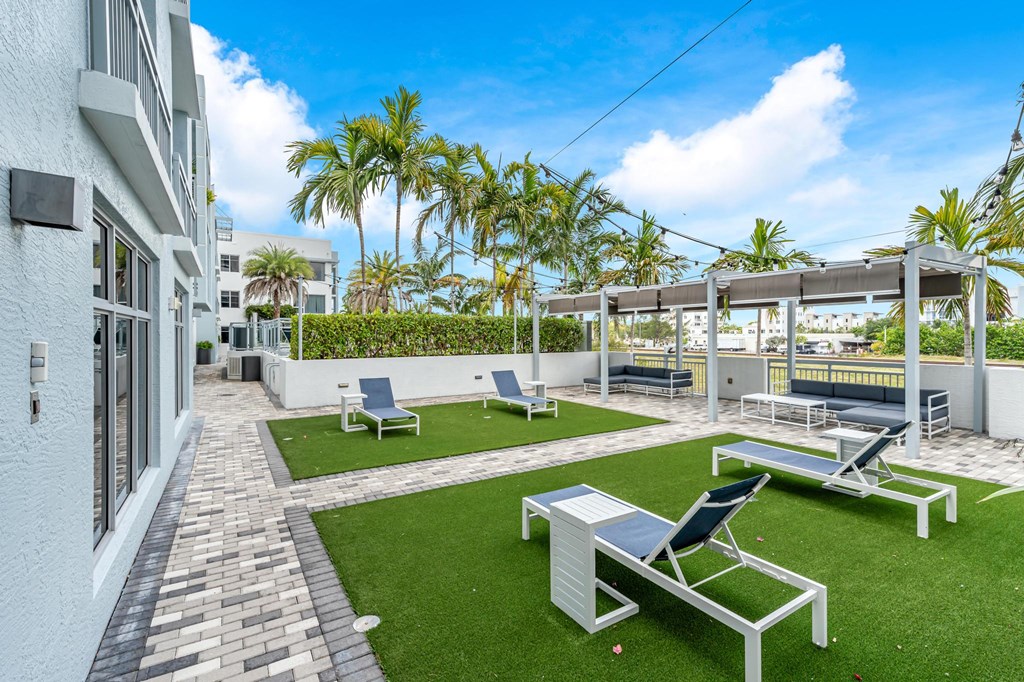 Tree-Lined Lounge Courtyard with Paved Walkways and Multiple Seating Zones
