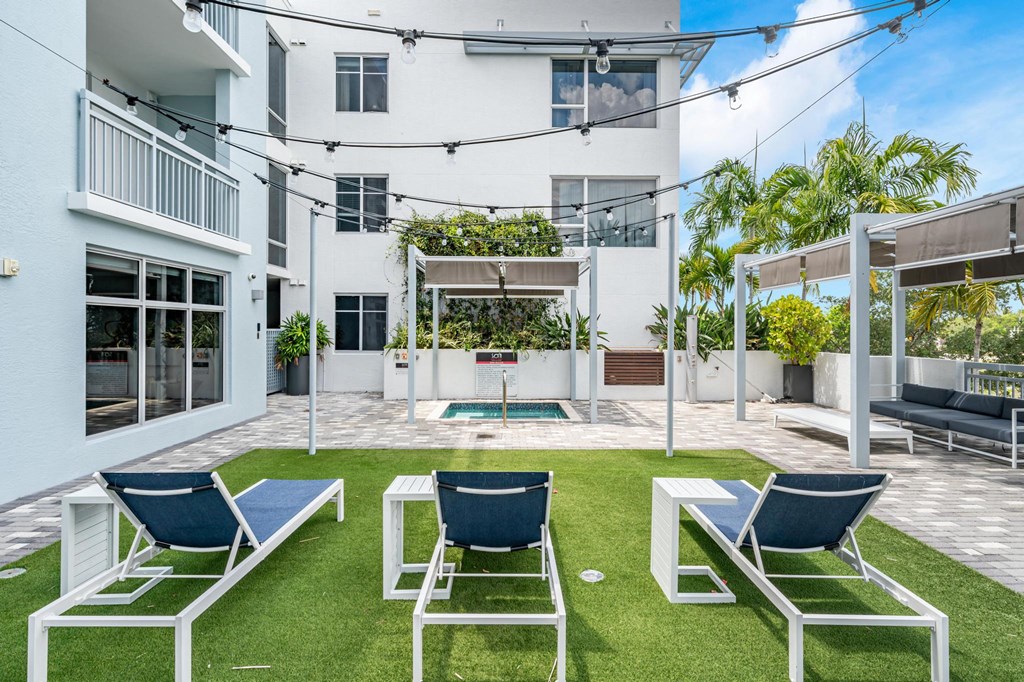 Outdoor Lounge Space With Covered Seating and Lawn Chairs