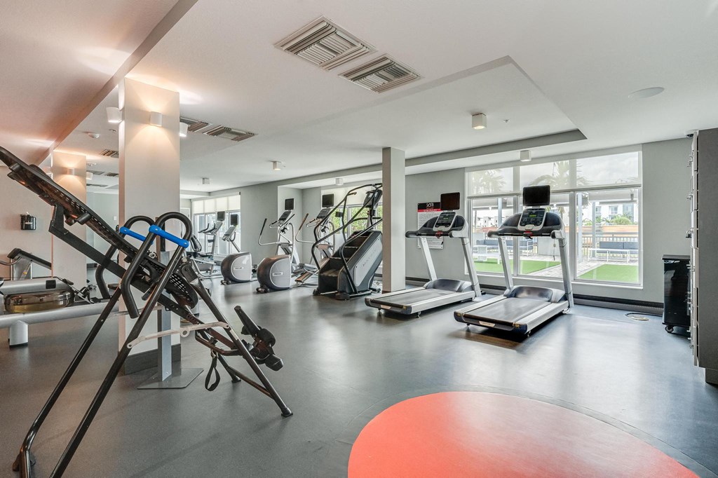 Fitness Center with Cardio Equipment and Outdoor Views Through Large Windows