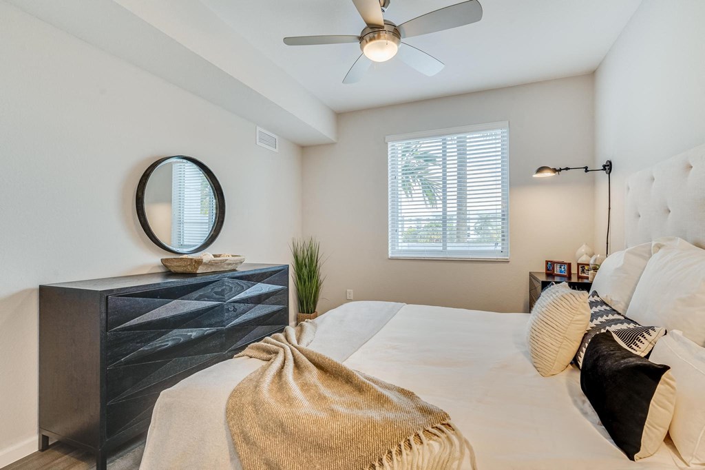 Bedroom with Double Nightstands, Light-Toned Flooring, and Framed Window for Natural Light