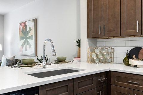 A kitchen with brown cabinets and a white countertop.