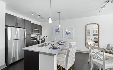 a kitchen and dining area with a stainless steel refrigerator
