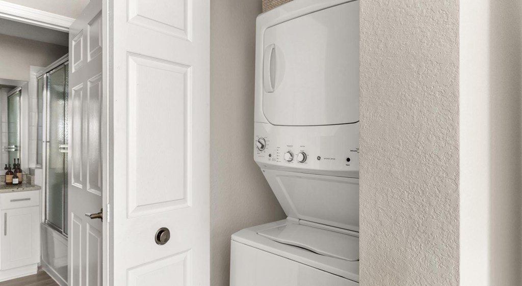 A white oven in a kitchen with a white door.