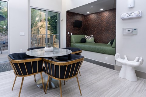 A modern dining room with a glass table and chairs.