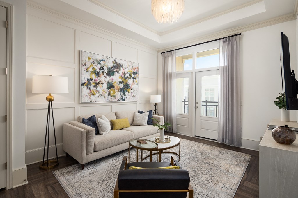 Apartment Lounge Area Featuring Large Artwork and Windowed Doors