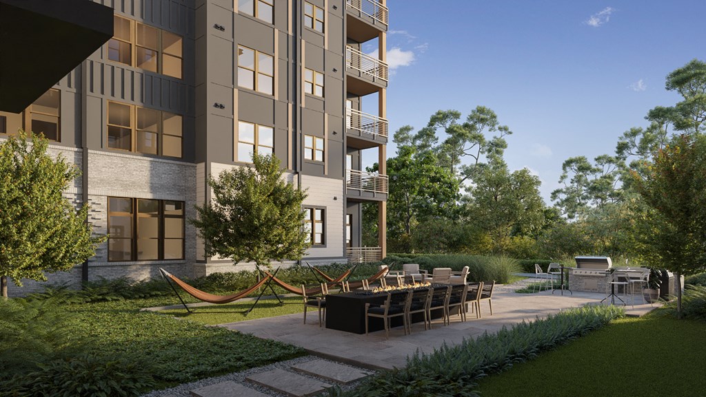 a rendering of an apartment building with a patio with a table and chairs