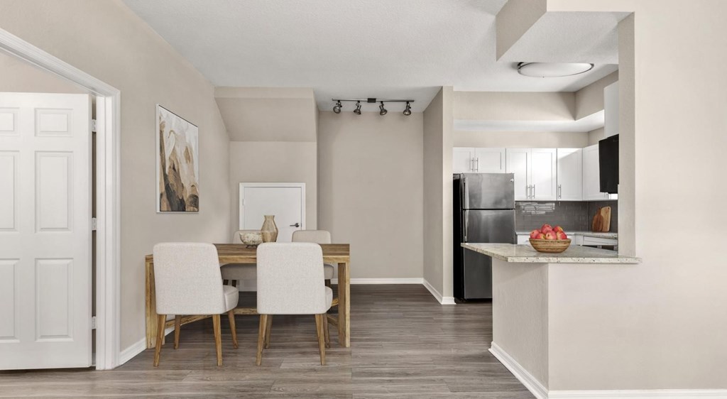 A modern kitchen with a dining table and chairs.