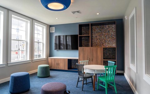 a dining room with a table and chairs and a tv