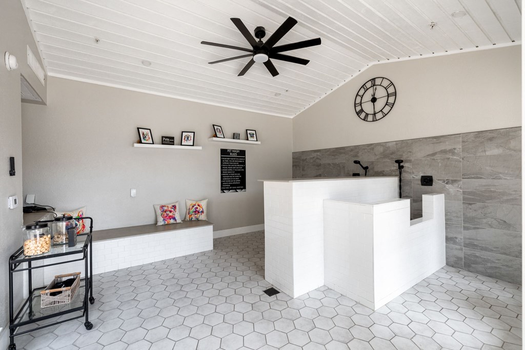 a large white reception desk with a large clock on the wall