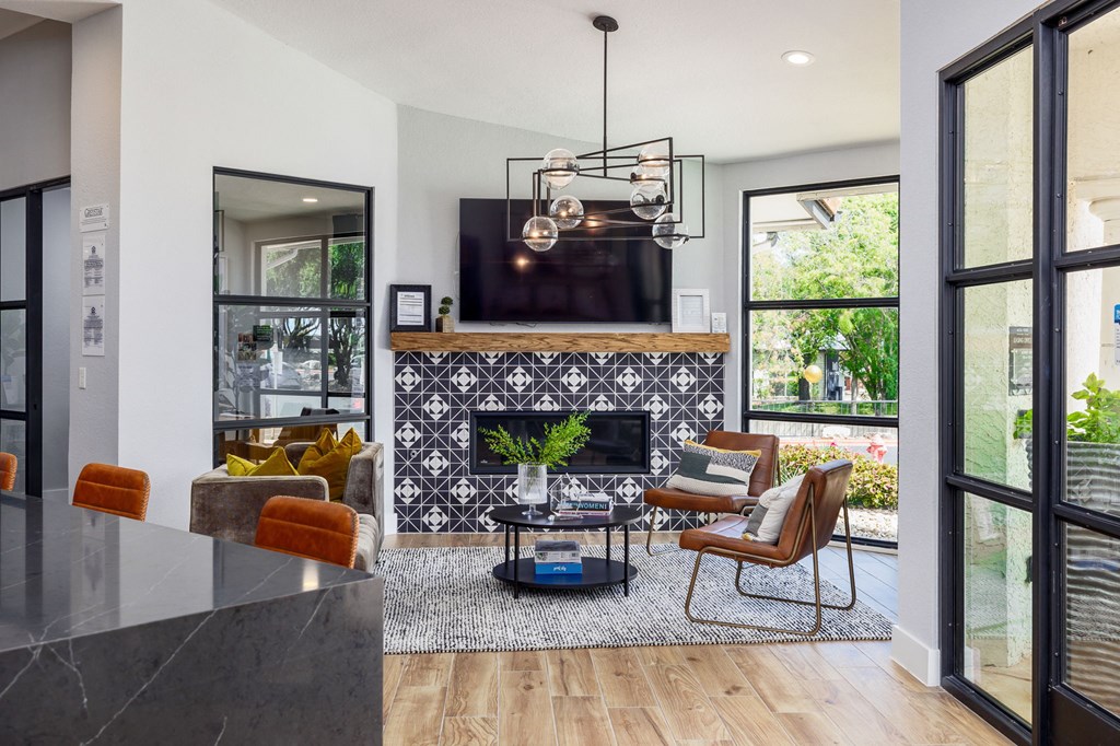 a living room with a fireplace and a tv on the wall