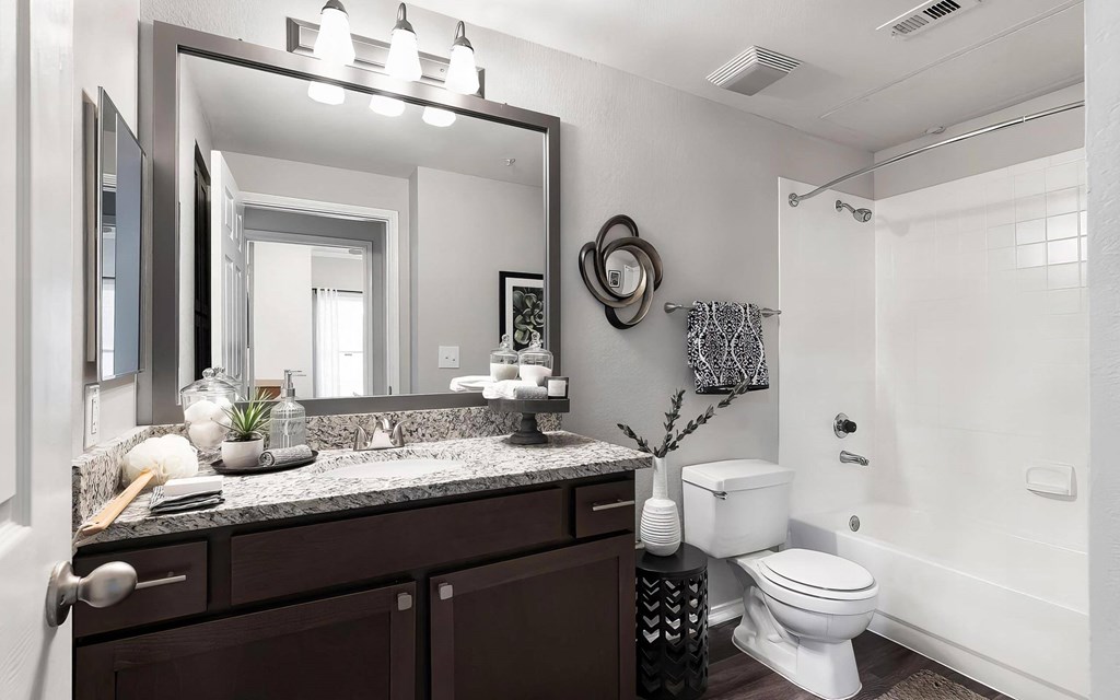 Mesa Verde Bathroom Upgraded Bathroom with Granite Vanity Framed Mirror Curved Shower Curtain Rod