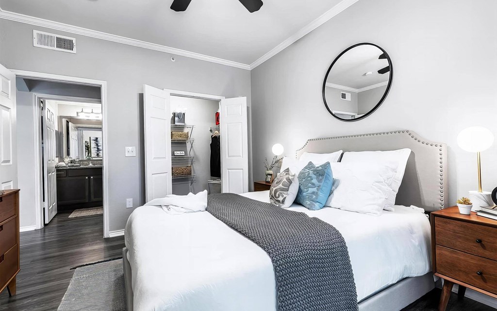 Mesa Verde Bedrooms Bright and Spacious Bedroom with Wood Look Vinyl Flooring Ceiling Fan Crown Molding and Closet with Built in Shelving
