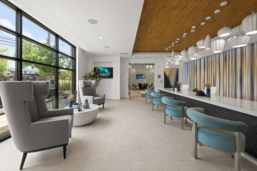 A modern living room with a grey armchair and a white coffee table.