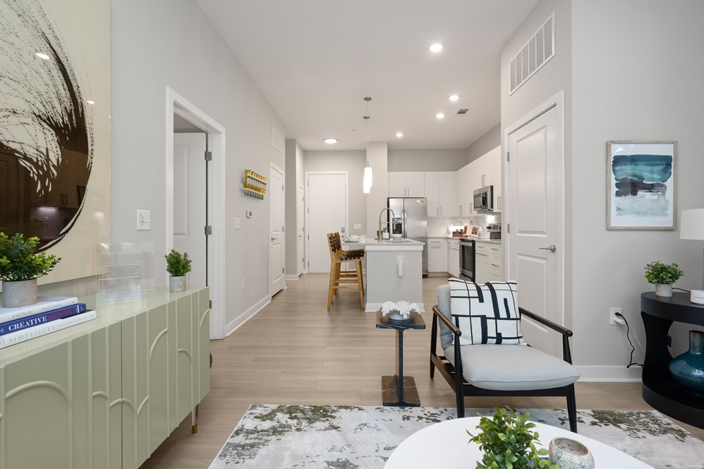 A well-lit, modern kitchen with a dining area and a living room.