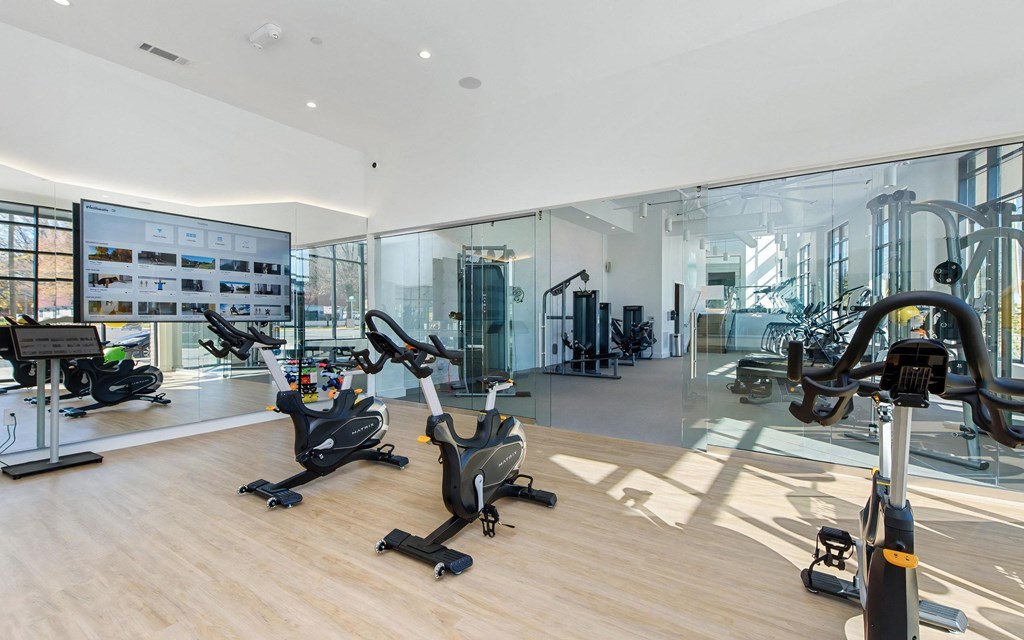 Fitness Studio Featuring Cardio Bikes, Virtual Training, and Mirrored Wall