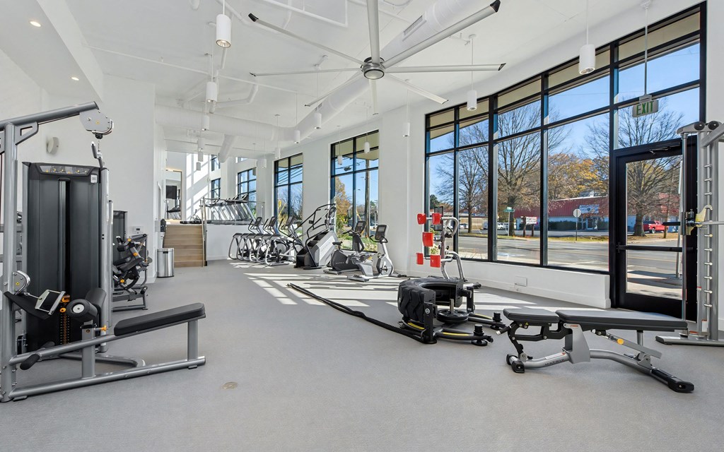 Gym with Cable Weights, Treadmills, and Expansive Street-Facing Windows