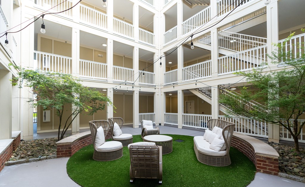 Serene Courtyard Surrounded by Balcony Walkways and Natural Landscaping