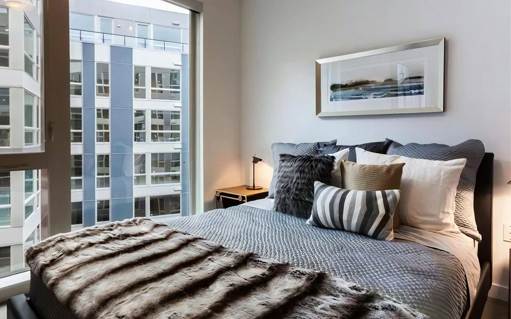 Bedroom with Tall Windows and Coordinated Bedding and Wall Art