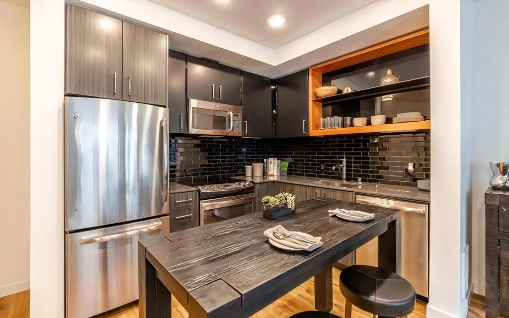 Built-In Appliances and Overhead Lighting in Open Kitchen Layout