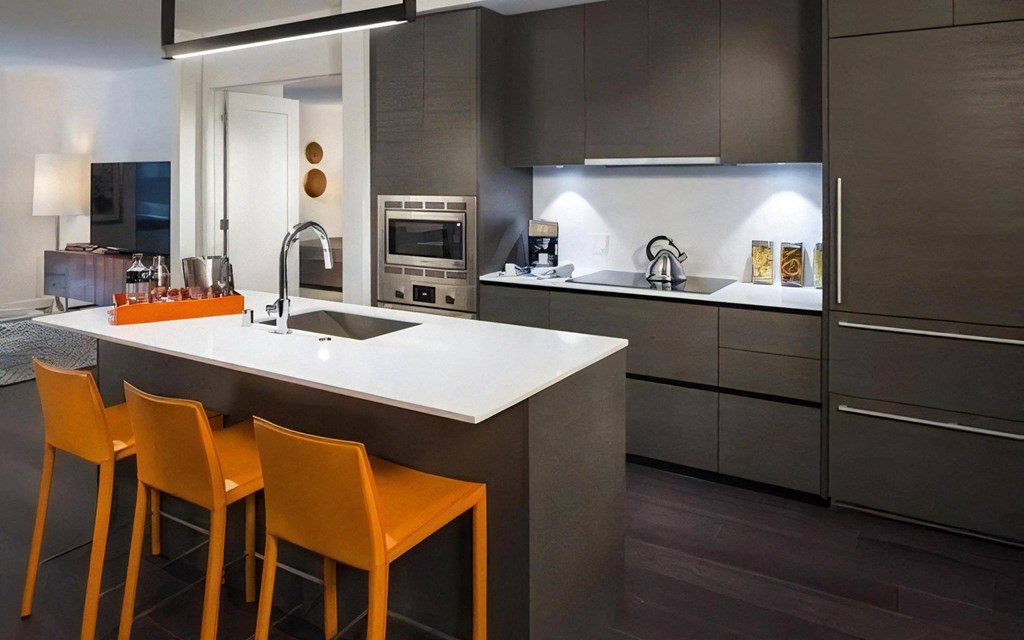 Full Wall Kitchen with Upper and Lower Cabinets and Under-Cabinet Lighting