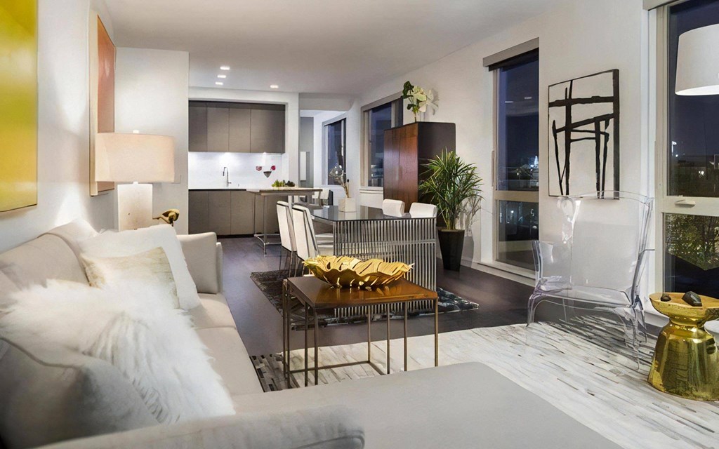 Apartment Interior with Multiple Seating Areas and Floor-to-Ceiling Windows