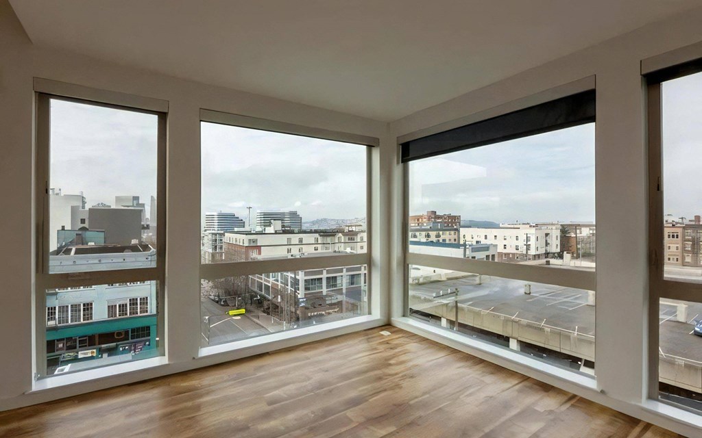 Apartment Living Space with Oversized Windows and Wood Floors