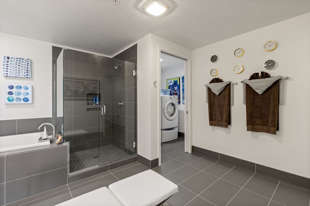 A modern bathroom with a walk-in shower and a toilet.