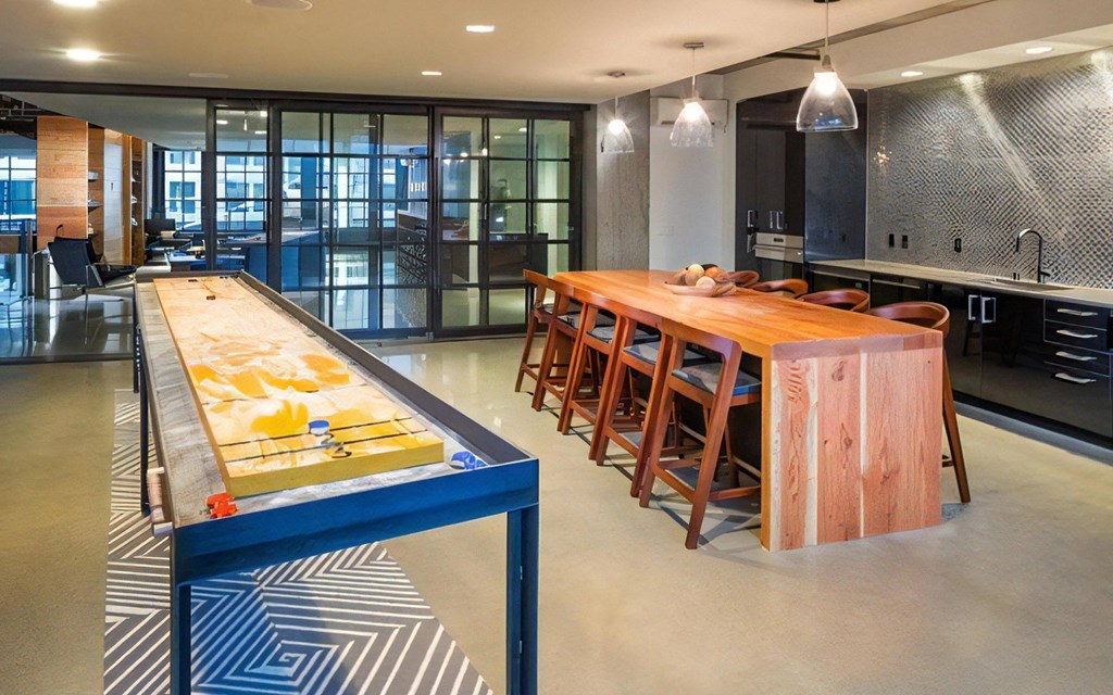 Indoor Resident Lounge with Kitchen, Shuffleboard, and Bar Seating