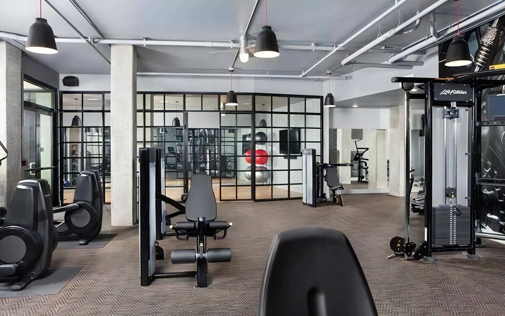 Apartment Fitness Area with Weight Machines and Studio Room