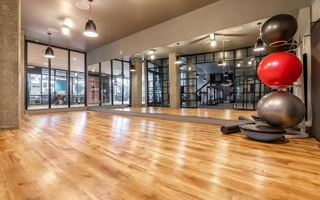 Fitness Studio Featuring Wood Flooring and Yoga Equipment