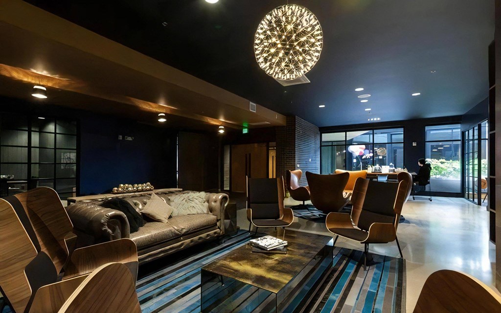 Community Lounge with Multiple Seating Areas and Overhead Lighting