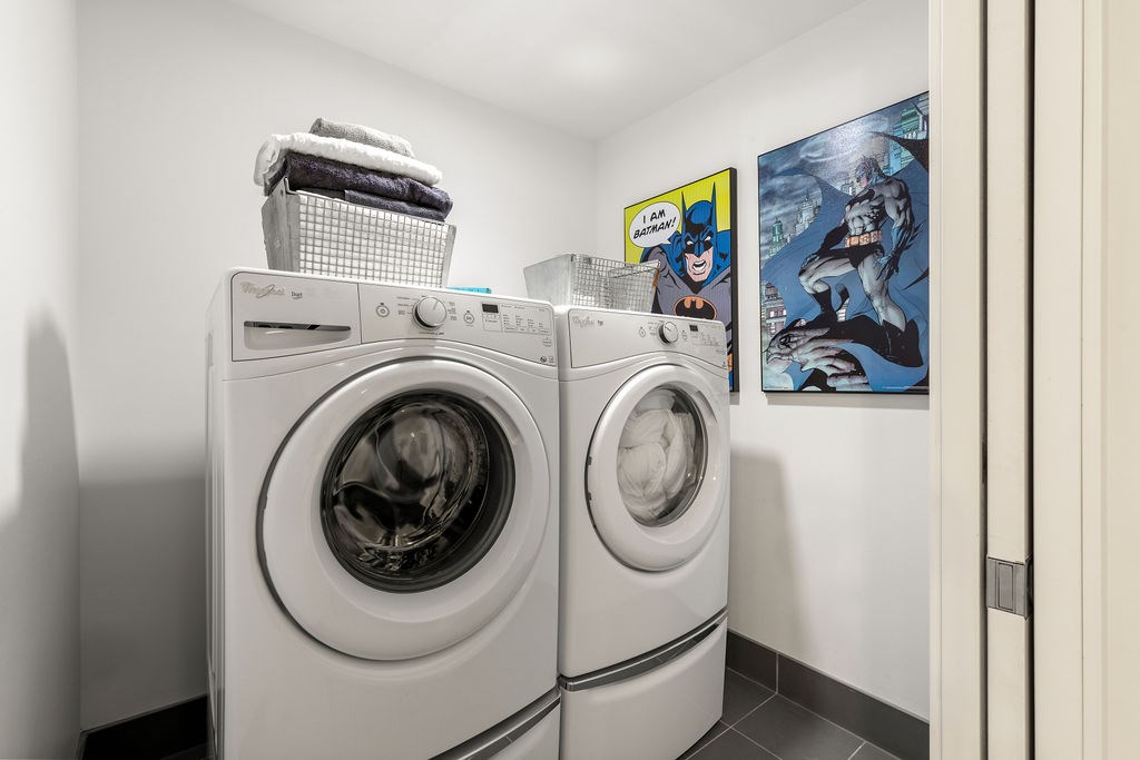 Two front loading washing machines in a laundry room.