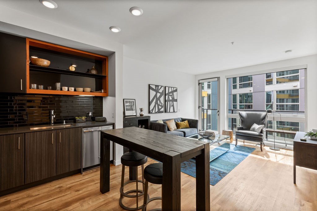 A modern kitchen with a wooden table and chairs.