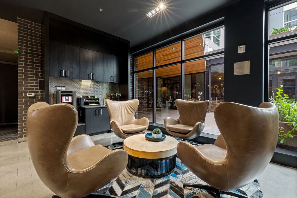 A modern living room with a coffee table and four chairs.