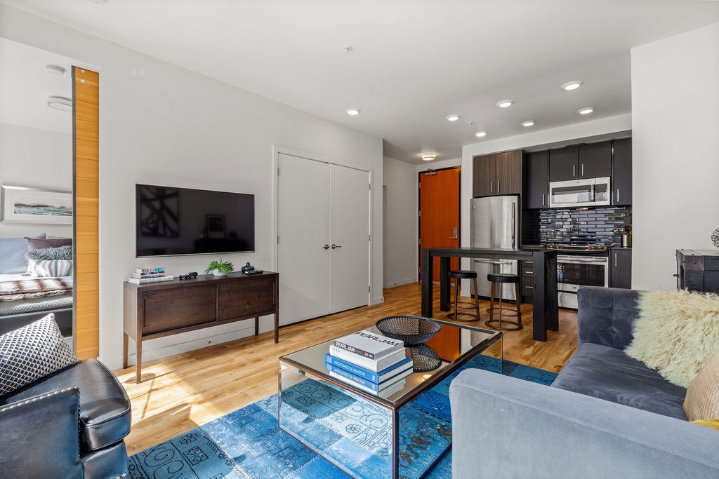 A modern living room with a grey couch and a coffee table.