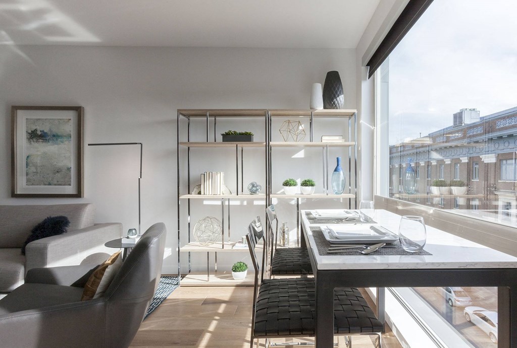 Living Room with Wall Shelving, Dining Table, and Large Window