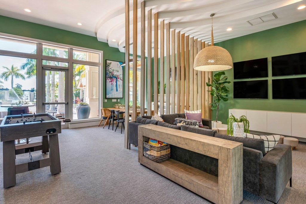 A room with a green wall and a wooden bench.