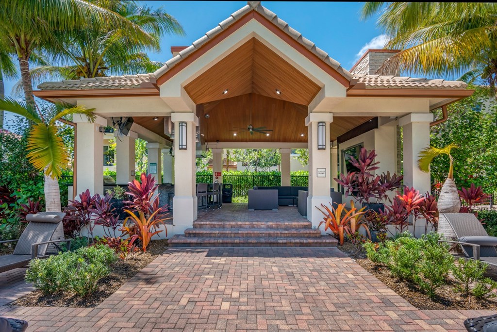 A house with a white porch and a brown roof.