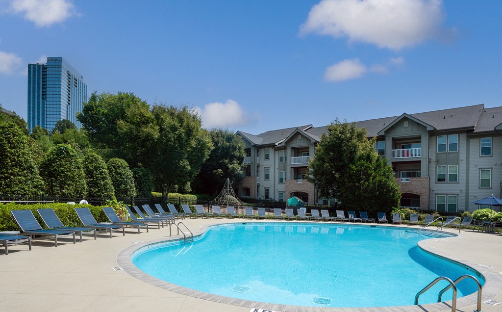 Resort-Style Pool with Ample Lounge Seating and Lush Landscaping