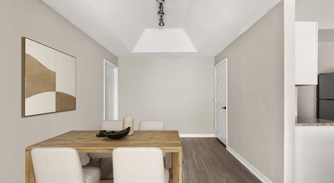 Dining room with a light wood table, four upholstered chairs, a pendant fixture and framed abstract art on the wall.