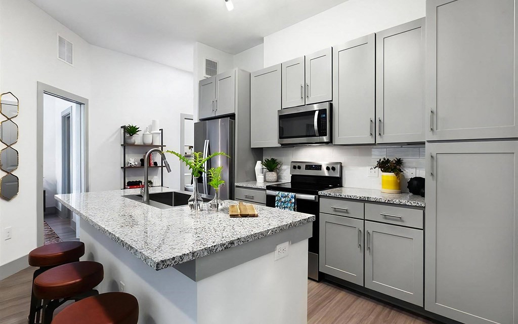 Rhythm High-End Kitchen with Granite Counters and Stainless Steel Appliances