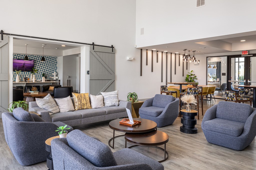 Rhythm Resident Lounge with grey chairs and a grey sofa.