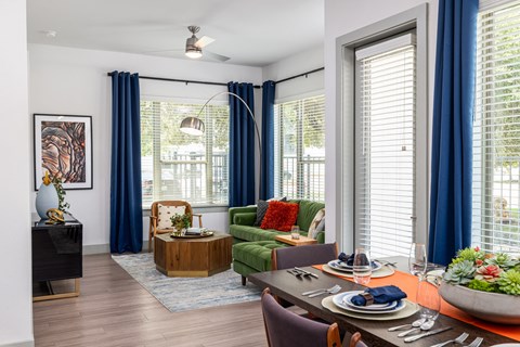 A dining room with a table set for a meal.