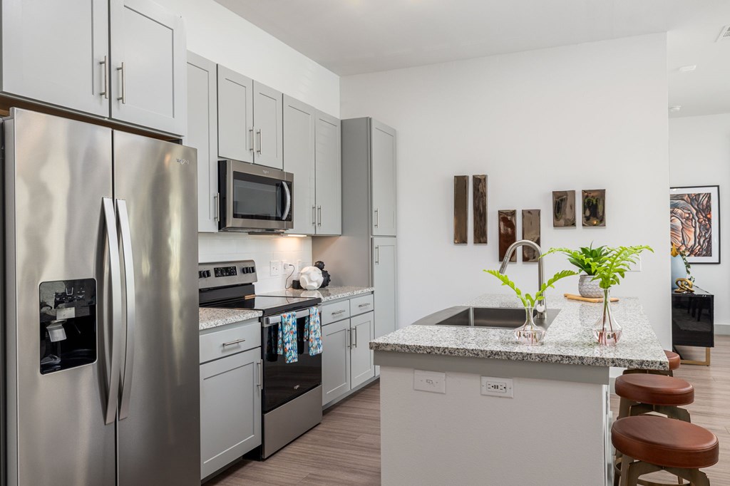 Rhythm High-End Kitchen with Granite Counters and Stainless Steel Appliances