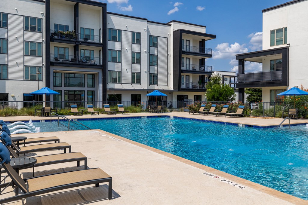 Rhythm Resort-Style Pool with Chaise Lounge Seating and Sundeck