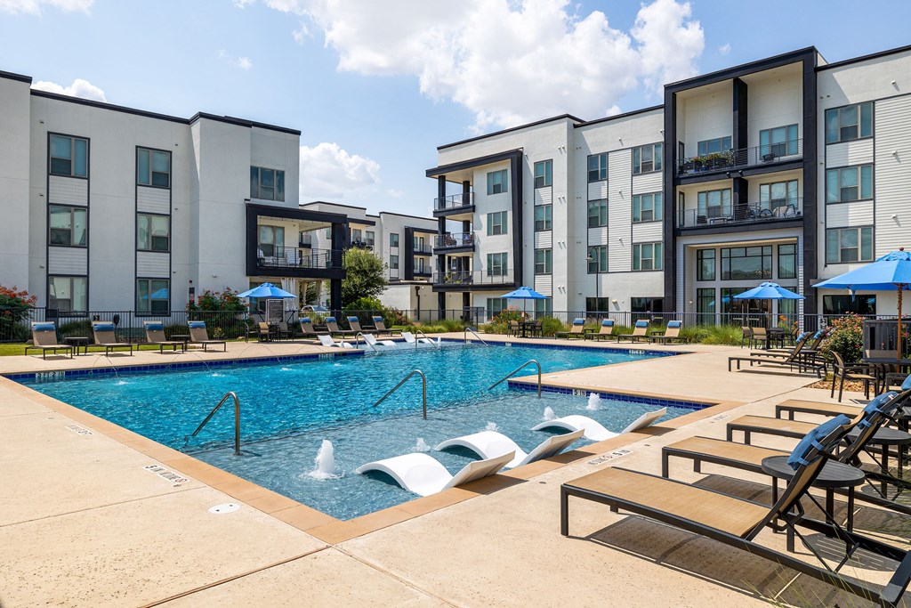 Rhythm Resort-Style Pool with Chaise Lounge Seating and Sundeck