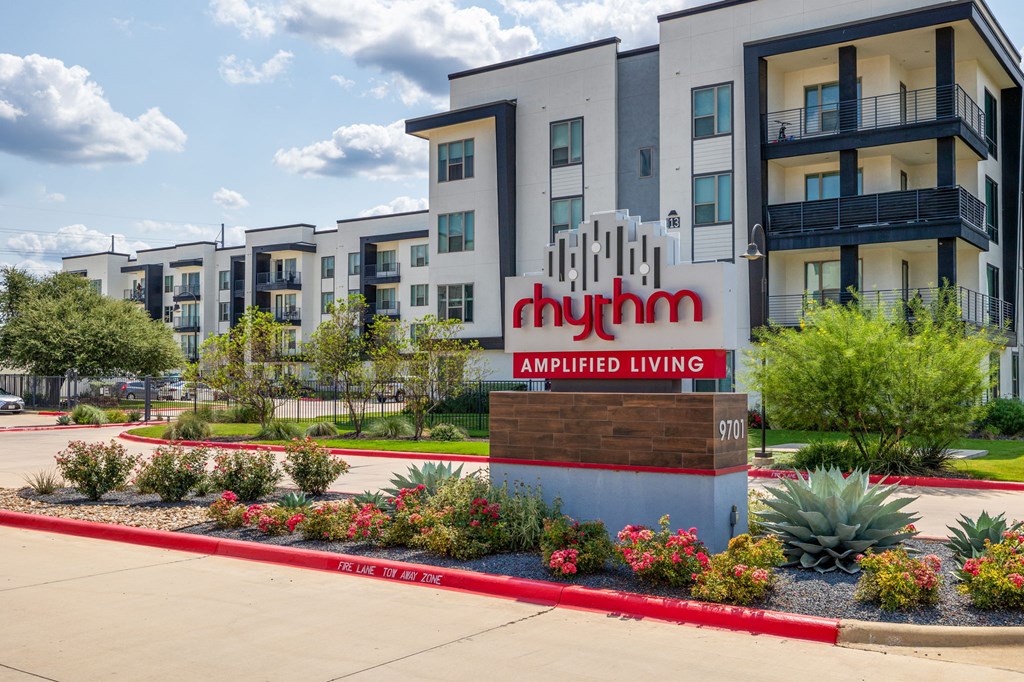 Rhythm Exterior Sign with landscaping and oversized balcony