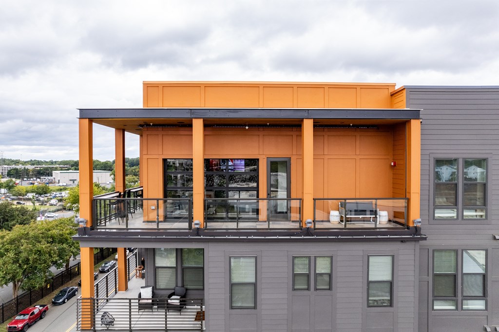 A modern building with a grey and orange facade.