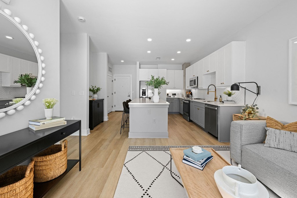 A modern kitchen with white cabinets and a large island.