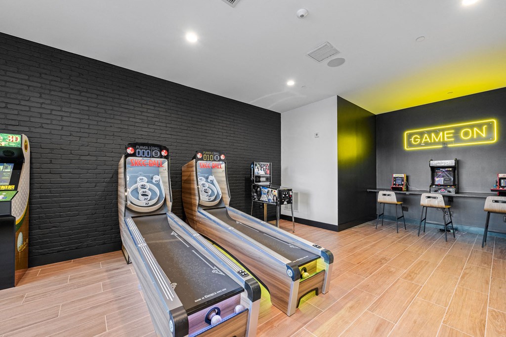 A room with a bowling alley and a sign that says "GAME ON".